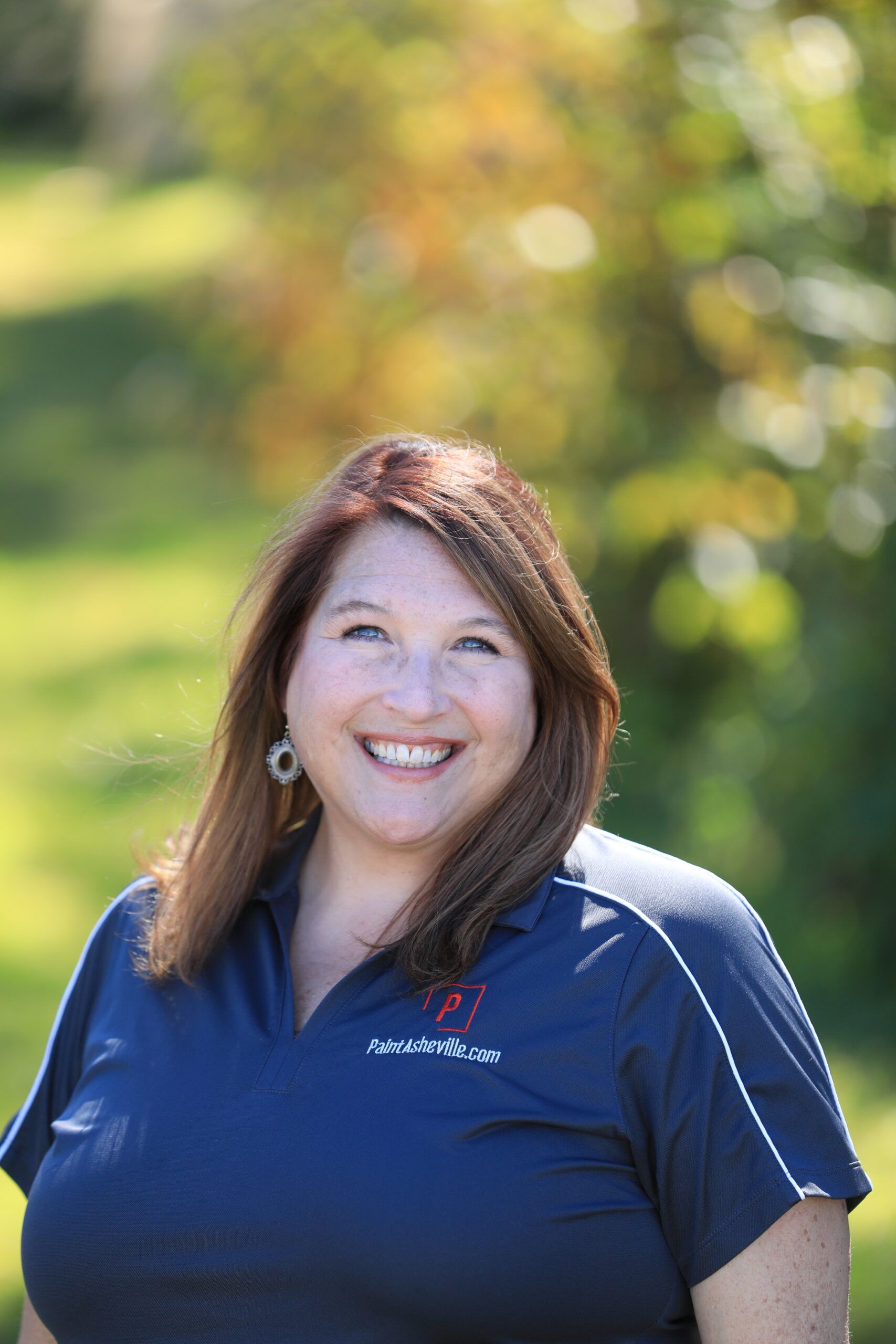 Smiling woman outdoors in navy polo