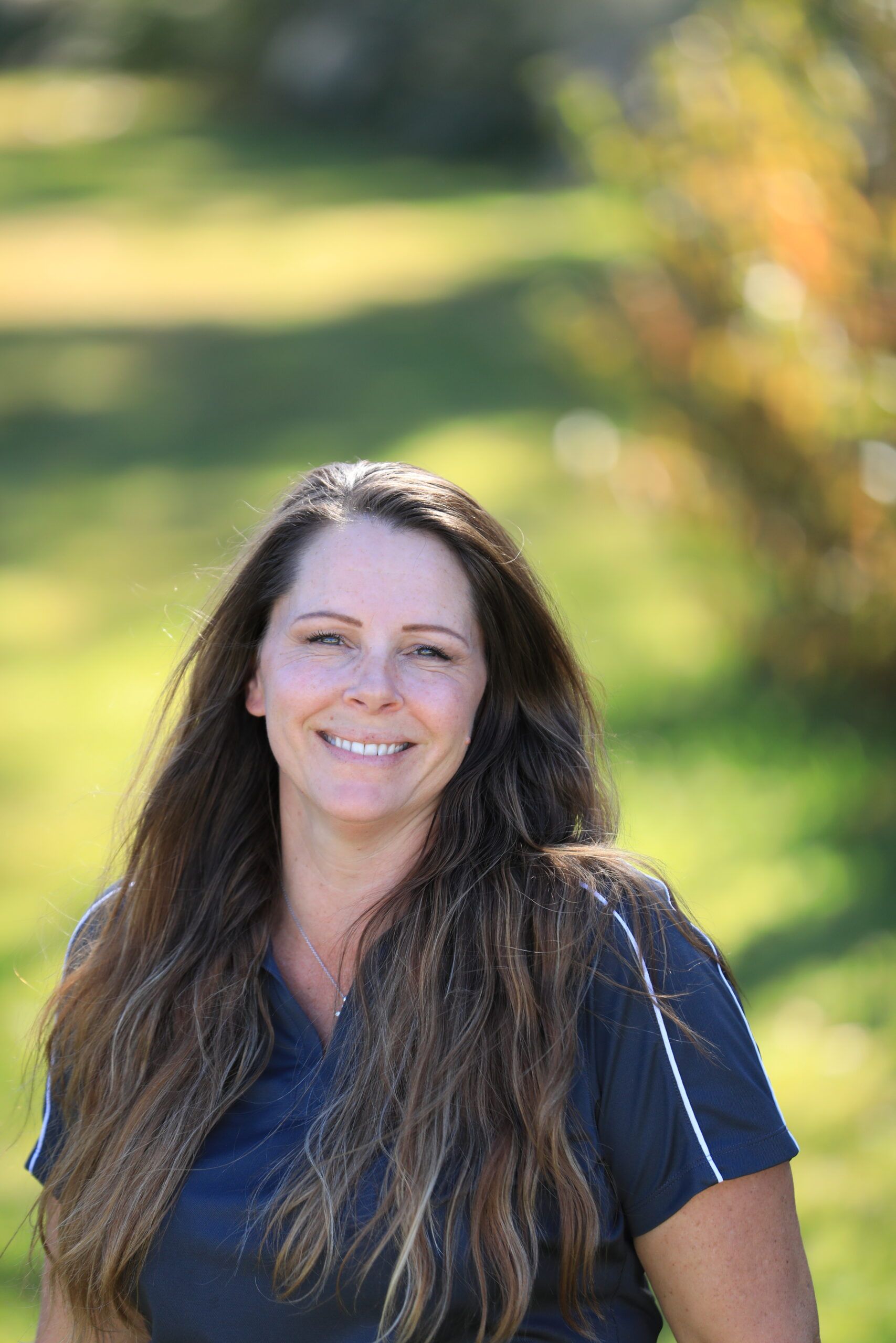 Smiling woman with long hair outdoors