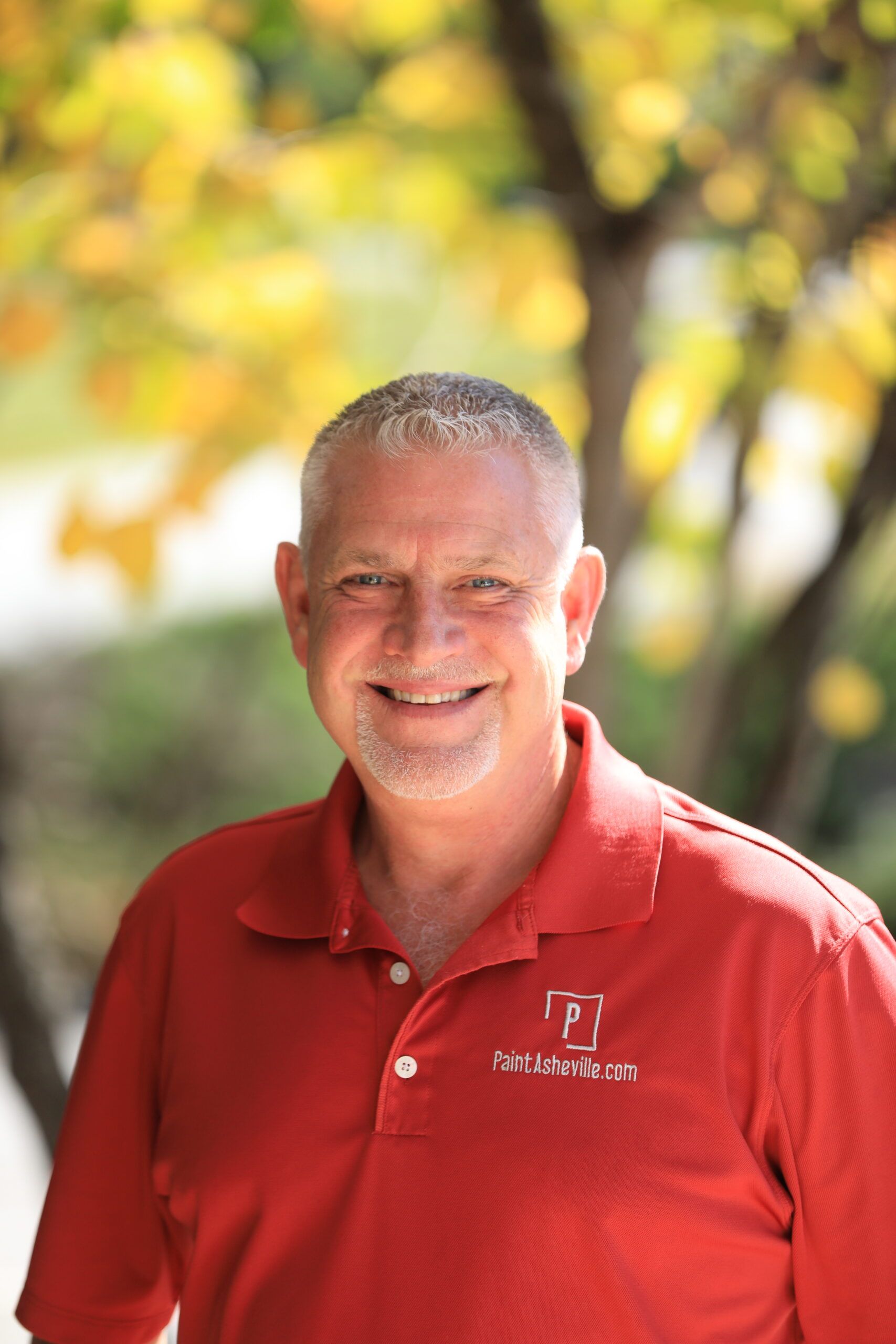 Smiling man in red polo shirt