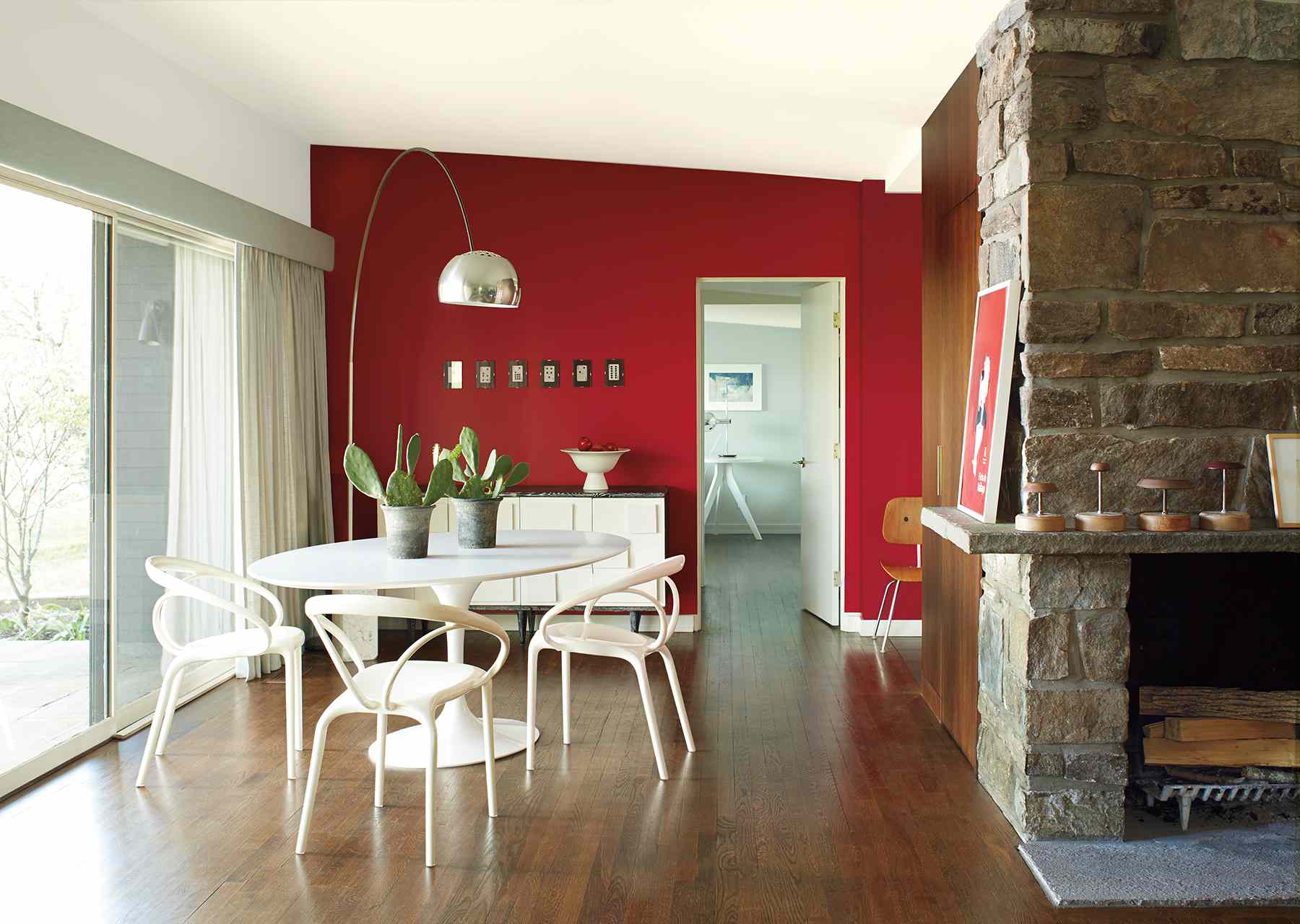 room with red walls and fireplace with white table